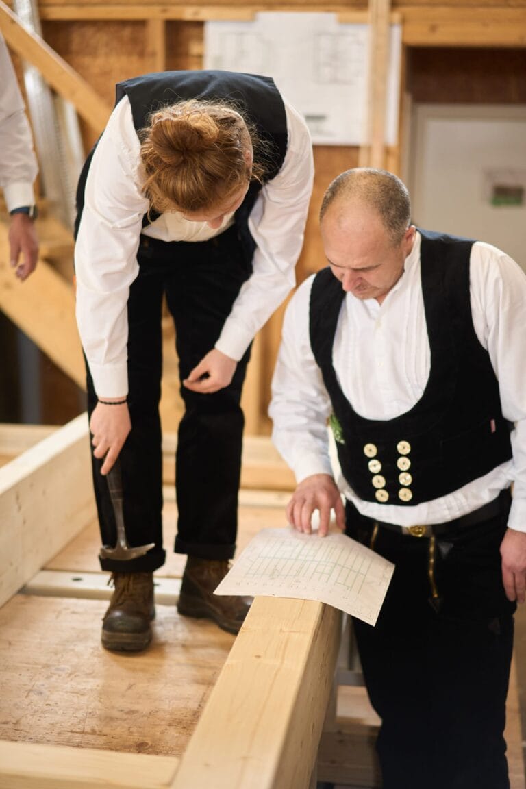 Handwerker bearbeitet Holzbalken mit Hobel – industriefotografie Karlsruhe
